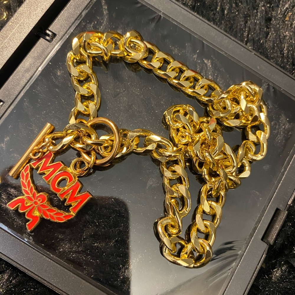 Authentic Mcm charm pull on a  18 karat gold plated, sterling, silver chain